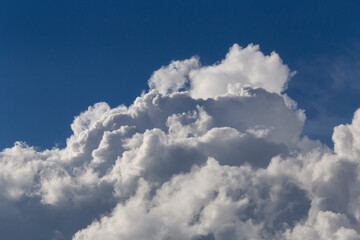 fluffy rain cloud in a clear blue sky