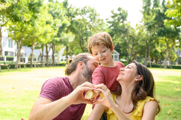 Happy family spending time on holiday. mother, father and little son having picnic in nature on a summer day. Leisure, summer, childhood concept.