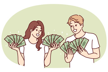 Man and woman with lot of cash in hands brag about money they earned from business or winning jackpot in lottery. Couple rich guys girls with money want to invest savings or invest in startup