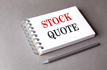 STOCK QUOTE MARGIN text on notebook on grey background