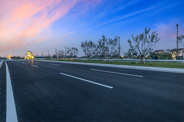 Fototapeta premium Countryside asphalt highway road and colorful sky clouds background