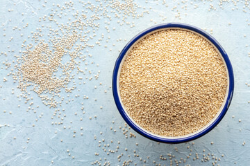 Quinoa in a bowl, healthy organic wood, uncooked, shot from the top with a place for text