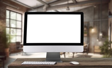 Fototapeta premium A white-screen blank laptop computer at Office workspace