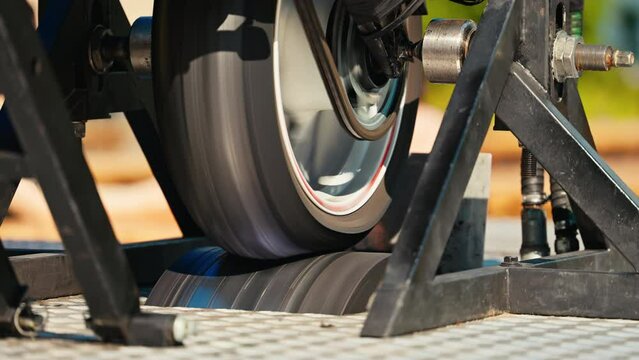 A train wheel is shown interacting with a track in slow motion, highlighting the precision involved in rail engineering