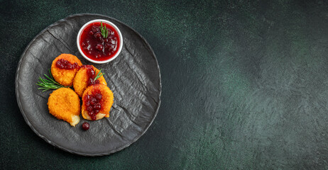 Baked Camembert breaded with cranberry sauce. camembert nuggets. Long banner format. top view. copy space for text