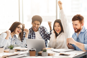 Yeah, exams passed. Emotional students expressing happines, looking at laptop screen in library