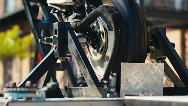 Closeup of Motorcycle Tire Spinning on Dyno Testing Machine, Showing Precision Engineering and Automotive Technology