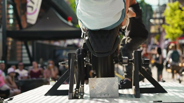 Slow Motion Action Captivating bike tricks at an outdoor event in front of a crowd of amazed spectators