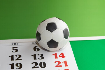 Futbol ball lying calendar with date 14th, final match, soccer weekend, European Football Championship