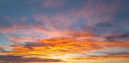 Sunrise background. Dramatic sunset background. Sky with clouds in Sunrise sky light background. Sunrise with clouds in various shapes background. Calm Sunrise.