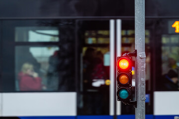 view of city traffic with traffic lights, in the foreground a traffic light with a red light