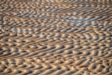 Close-up of sand pattern on the beach. Selective focus.