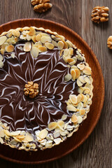 cake with nuts and chocolate on a wooden table