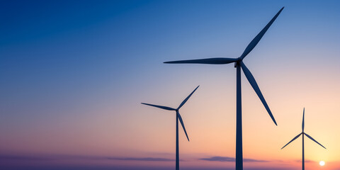 Fototapeta premium Wind turbines standing tall against a coastal sunset backdrop 