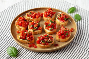Homemade Italian Tomato Bruschetta on a Plate, side view.