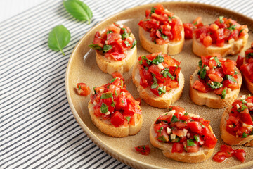 Homemade Italian Tomato Bruschetta on a Plate, side view. Copy space.