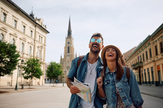 Cheerful couple having fun while sightseeing during their trip.