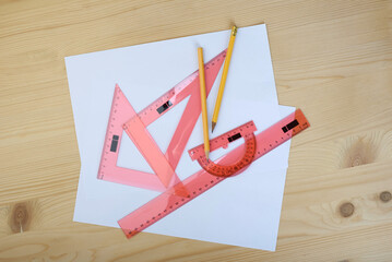 Fototapeta premium Drawing set made of rulers, traportir with pencils on sheets of paper.