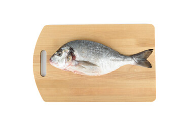 Fototapeta premium Shredded and scaled dorada fish on a cutting board.
