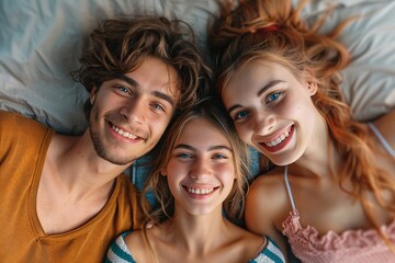 Fototapeta premium Couple on bed with two girls smiling