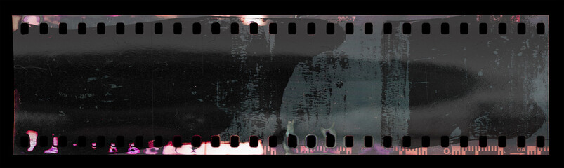 start of 35mm negative filmstrip with cool scanning light interferences and paint marks.