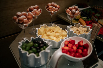 An assortment of beautifully arranged desserts, featuring vibrant fruits and delicate garnishes, perfect for a wedding celebration