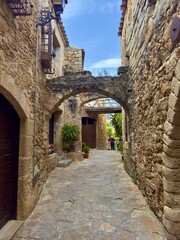 Pals, historic centre on a hill with small alleys and medieval Romanesque buildings at the evening light and blue sky, Begur, Girona, Catalonia, Costa Brava, Spain
