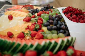 A beautifully arranged display of fresh fruits and desserts, showcasing vibrant colors and appetizing presentations, perfect for any special occasion