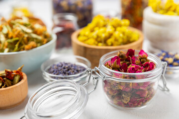 Assortment of dry herbal and berry tea on a wooden background. Tea party concept. medicinal herbs. Healing herbs.Alternative medicine.Linden, calendula, cornflowers, marigold, tansy, tea rose.