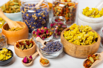Assortment of dry herbal and berry tea on a wooden background. Tea party concept. medicinal herbs. Healing herbs.Alternative medicine.Linden, calendula, cornflowers, marigold, tansy, tea rose.