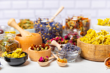 Assortment of dry herbal and berry tea on a wooden background. Tea party concept. medicinal herbs. Healing herbs.Alternative medicine.Linden, calendula, cornflowers, marigold, tansy, tea rose.
