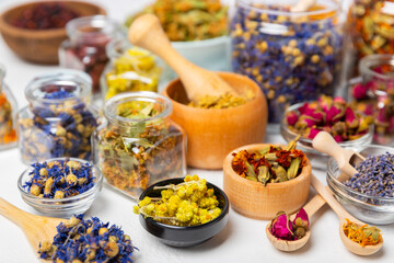 Assortment of dry herbal and berry tea on a wooden background. Tea party concept. medicinal herbs. Healing herbs.Alternative medicine.Linden, calendula, cornflowers, marigold, tansy, tea rose.