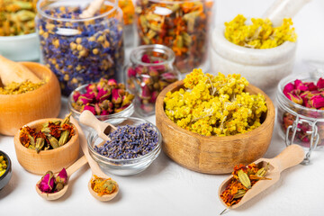 Assortment of dry herbal and berry tea on a wooden background. Tea party concept. medicinal herbs. Healing herbs.Alternative medicine.Linden, calendula, cornflowers, marigold, tansy, tea rose.