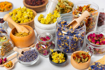 Assortment of dry herbal and berry tea on a wooden background. Tea party concept. medicinal herbs. Healing herbs.Alternative medicine.Linden, calendula, cornflowers, marigold, tansy, tea rose.
