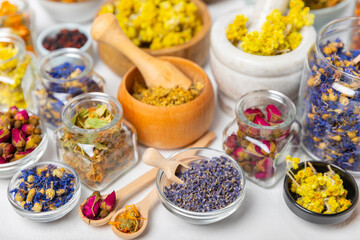 Assortment of dry herbal and berry tea on a wooden background. Tea party concept. medicinal herbs. Healing herbs.Alternative medicine.Linden, calendula, cornflowers, marigold, tansy, tea rose.