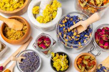 Assortment of dry herbal and berry tea on a wooden background. Tea party concept. medicinal herbs. Healing herbs.Alternative medicine.Linden, calendula, cornflowers, marigold, tansy, tea rose.