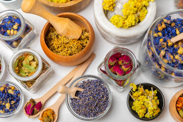 Assortment of dry herbal and berry tea on a wooden background. Tea party concept. medicinal herbs. Healing herbs.Alternative medicine.Linden, calendula, cornflowers, marigold, tansy, tea rose.