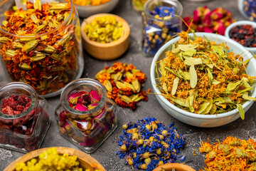 Assortment of dry herbal and berry tea on a wooden background. Tea party concept. medicinal herbs. Healing herbs.Alternative medicine.Linden, calendula, cornflowers, marigold, tansy, tea rose.