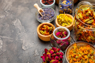 Assortment of dry herbal and berry tea on a wooden background. Tea party concept. medicinal herbs. Healing herbs.Alternative medicine.Linden, calendula, cornflowers, marigold, tansy, tea rose.