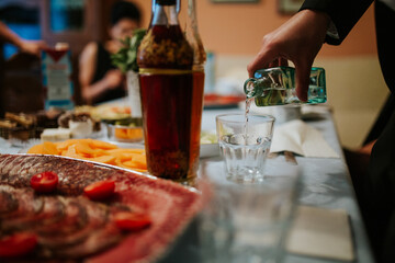 A close-up shot of a drink being poured into a glass, capturing the liquid in motion and highlighting the rich color and texture of the beverage.