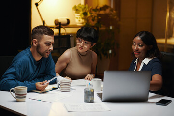 Businessman sharing ideas with colleagues in night meeting
