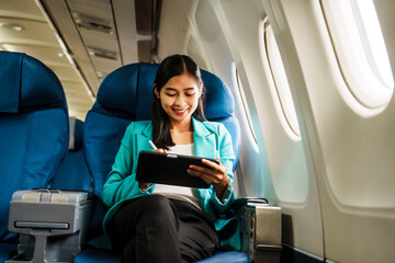 Asian attractive business woman passenger sitting on business class luxury plane while relax while travel concept