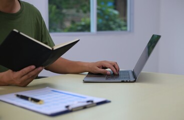 Looking at busy businessman's hands Using smartphones and laptops in the office, AI creates images.