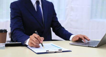 Looking at busy businessman's hands Using smartphones and laptops in the office, AI creates images.