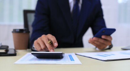 Looking at busy businessman's hands Using smartphones and laptops in the office, AI creates images.