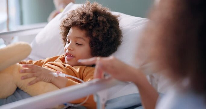 Boy, smile and teddy bear in hospital on bed for health, healthcare and medical support with mom. Male child, happy and stuffed animal in clinic for wellness, results and emotional care with mother