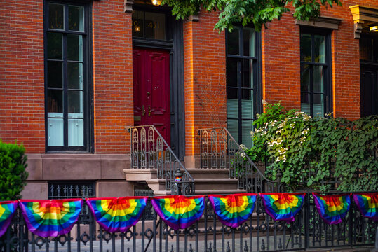 NYC gay pride flags along the fence - Powered by Adobe
