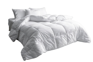 A pristine white bed with a fluffy duvet and pillows, inviting and serene.