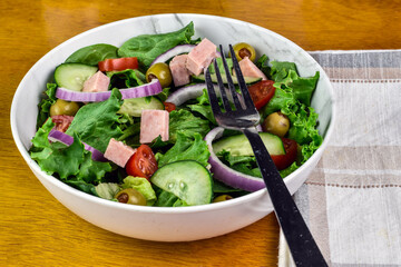 salad top with tomatoes cucumbers and  spam