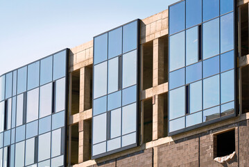 Building construction, glazing facade of new building. Mount insulated glass panels on facade of...